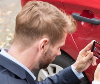 Person Taking Picture Of Damaged Car